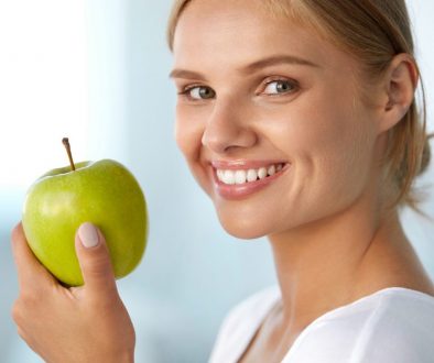 Woman With Apple. Beautiful Girl With White Smile, Healthy Teeth